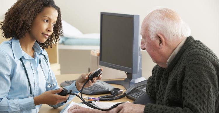 GP doctor doing blood pressure test