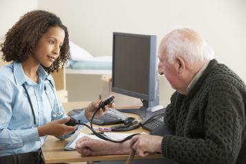 GP doctor doing blood pressure test