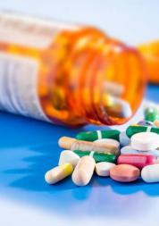 medication pouring out of a bottle 